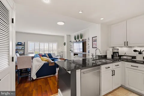 a kitchen with stainless steel appliances granite countertop a sink and cabinets