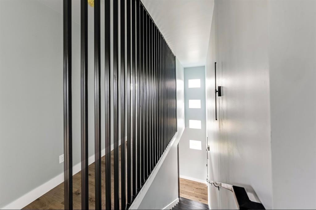 1113 East Oleander Street Fort Worth, TX 76104 - Photo 20 of 39 Staircase featuring wood finished floors