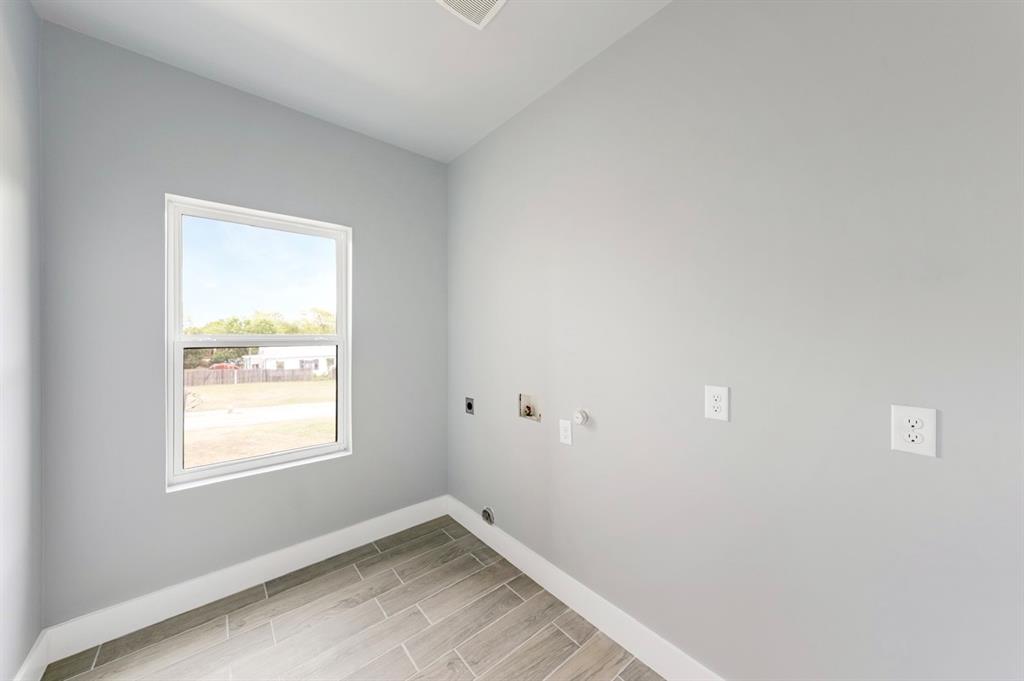 1113 East Oleander Street Fort Worth, TX 76104 - Photo 22 of 39 Laundry area with electric dryer hookup, wood finish floors, hookup for a gas dryer, and washer hookup