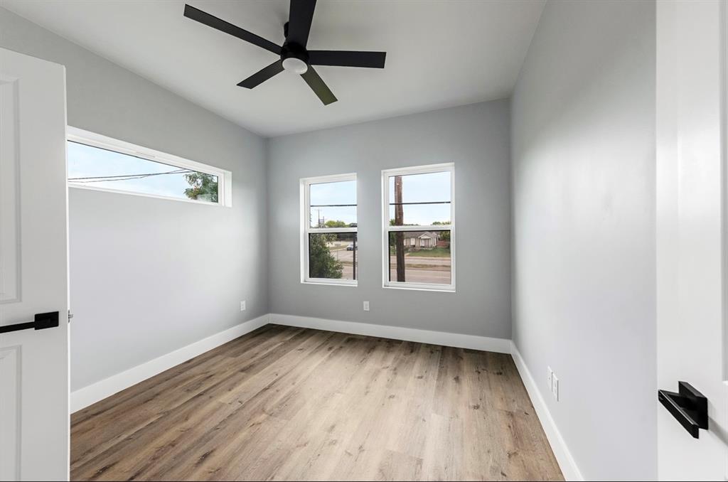 1113 East Oleander Street Fort Worth, TX 76104 - Photo 23 of 39 Empty room featuring light wood-style flooring and ceiling fan