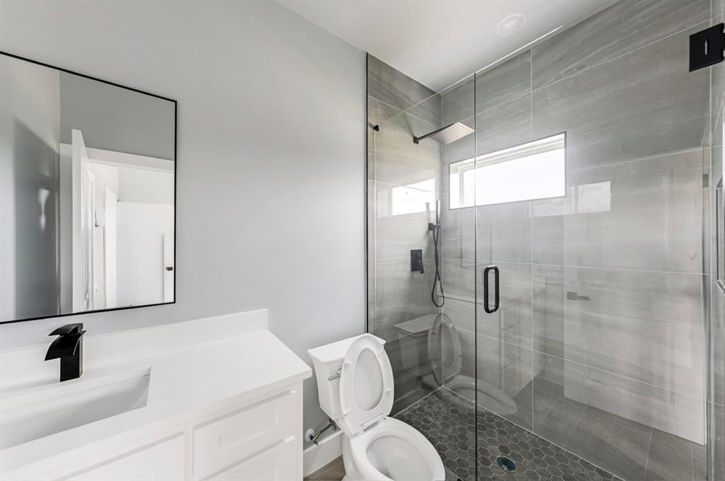 1113 East Oleander Street Fort Worth, TX 76104 - Photo 24 of 39 Bathroom with vanity and a stall shower