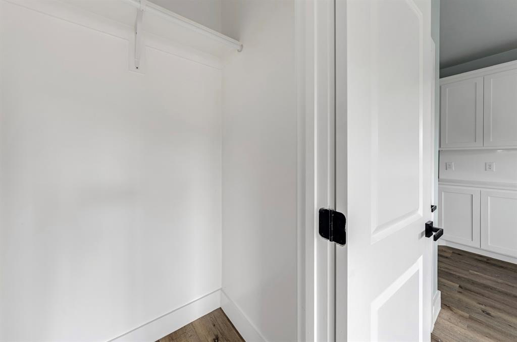 1113 East Oleander Street Fort Worth, TX 76104 - Photo 25 of 39 Spacious closet featuring dark wood finished floors