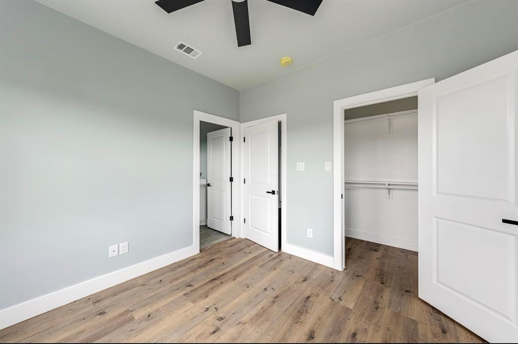 1113 East Oleander Street Fort Worth, TX 76104 - Photo 26 of 39 Unfurnished bedroom with wood finished floors and a ceiling fan