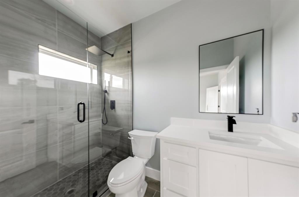 1113 East Oleander Street Fort Worth, TX 76104 - Photo 27 of 39 Bathroom featuring vanity and a stall shower