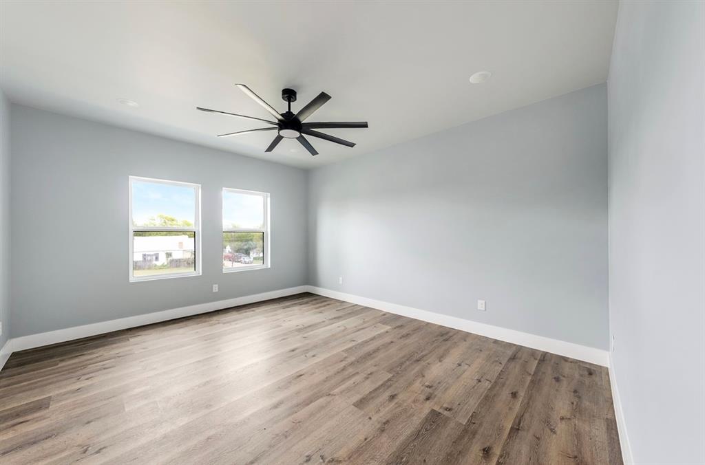 1113 East Oleander Street Fort Worth, TX 76104 - Photo 29 of 39 Spare room with light wood-style floors and ceiling fan