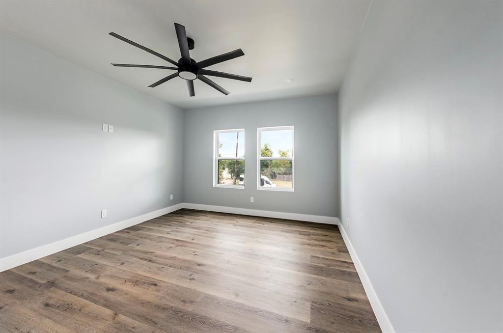 1113 East Oleander Street Fort Worth, TX 76104 - Photo 30 of 39 Empty room featuring wood finished floors and a ceiling fan