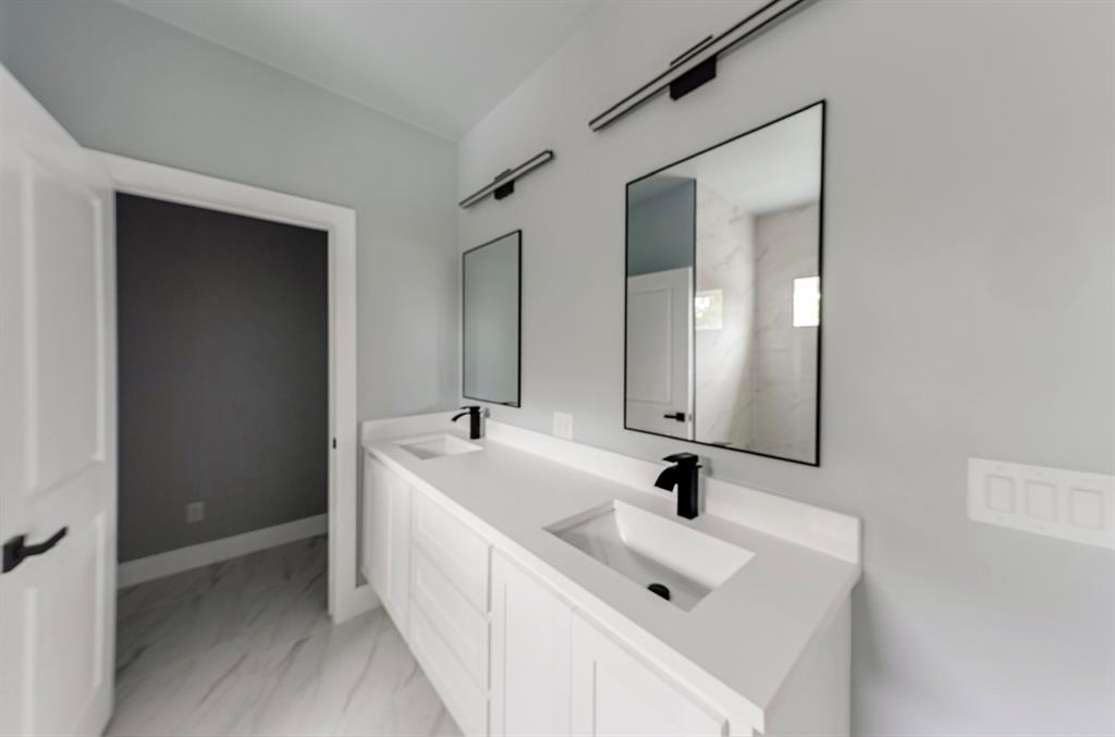 1113 East Oleander Street Fort Worth, TX 76104 - Photo 34 of 39 Full bath with double vanity and light marble finish flooring