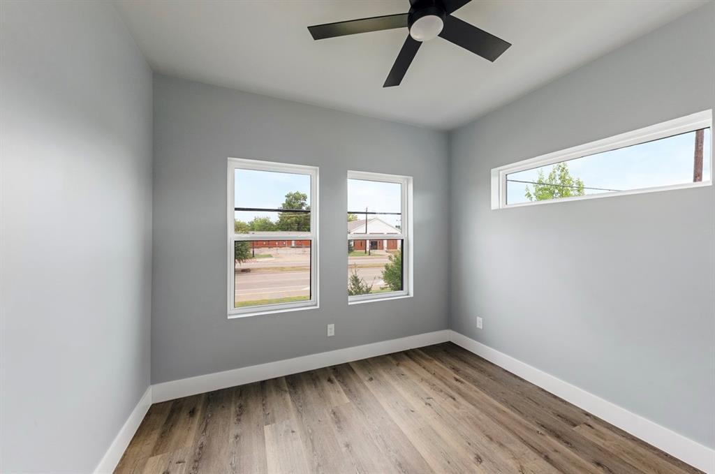1113 East Oleander Street Fort Worth, TX 76104 - Photo 38 of 39 Spare room featuring plenty of natural light, light wood-style floors, and a ceiling fan