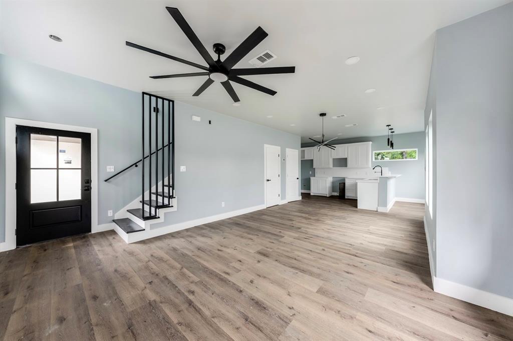 1113 East Oleander Street Fort Worth, TX 76104 - Photo 6 of 39 Unfurnished living room with light wood-type flooring, stairway, a ceiling fan, and recessed lighting