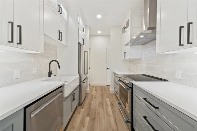 a kitchen with a sink appliances and cabinets