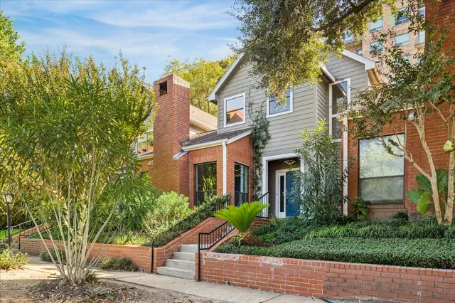 front view of a house with a tree