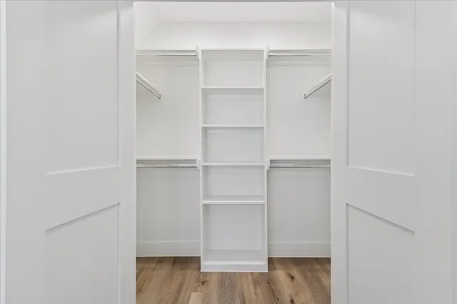 a view of walk in closet with empty racks