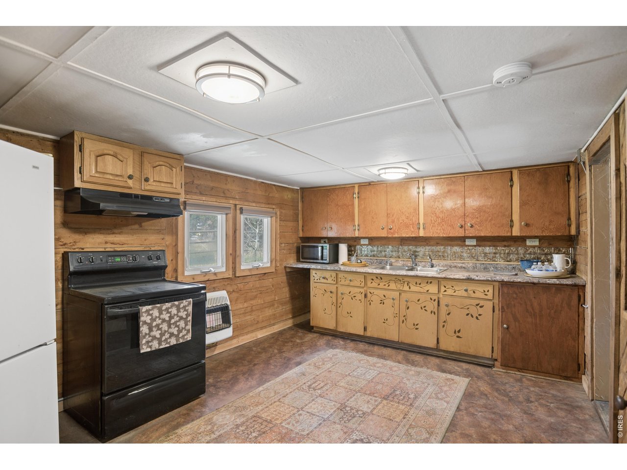 27 Gap Road Black Hawk, CO 80422 - Photo 10 of 36 a kitchen with stainless steel appliances kitchen island granite countertop a stove a sink and a microwave
