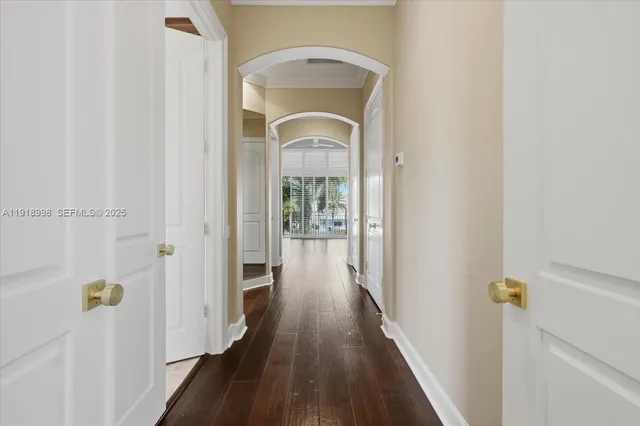 a view of a hallway with wooden floor and glass door