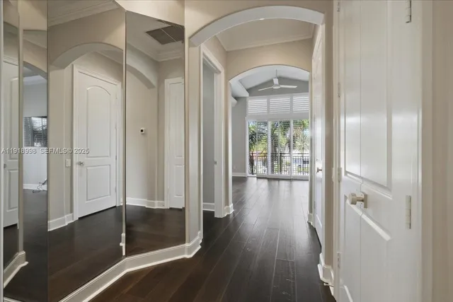 a bedroom with a large bed and wooden floor