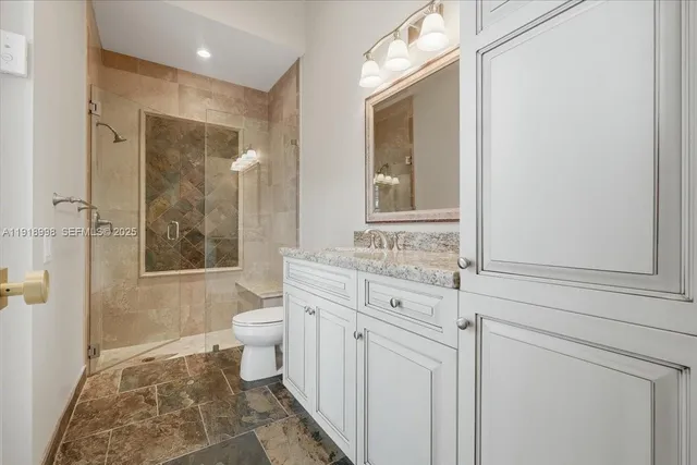 a spacious bedroom with a bed and a dresser