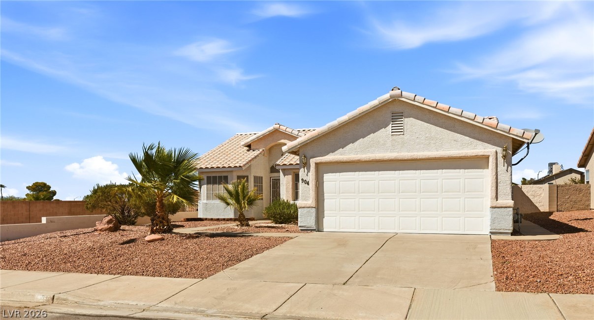 904 Shadowfax Road Henderson, NV 89015 - Photo 1 of 31 A classic stucco exterior features low-maintenance desert landscaping and a tiled roof.