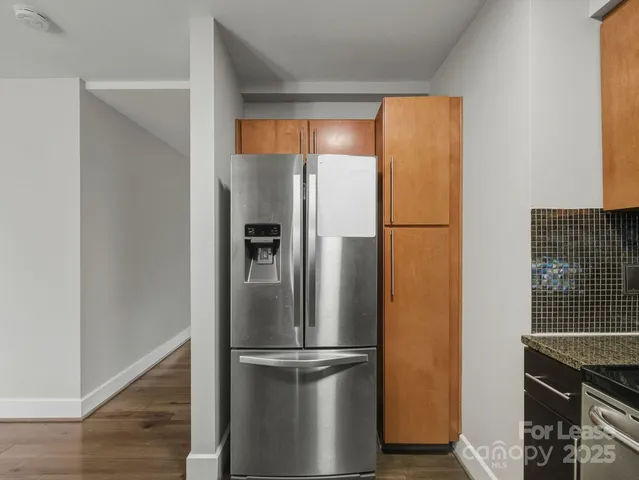 a metallic refrigerator freezer sitting in a kitchen