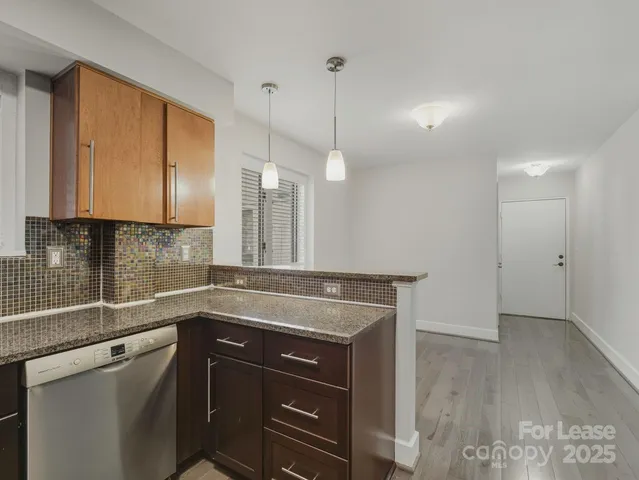 a kitchen with a sink a counter space and stainless steel appliances