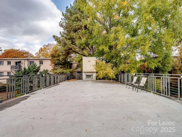 a view of a house with a wooden fence