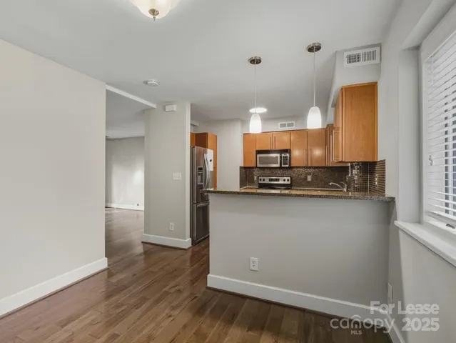 a view of a kitchen with a sink and a refrigerator
