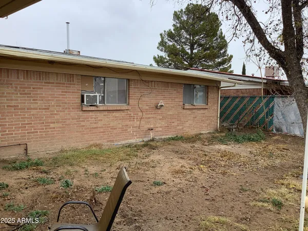 a view of dirt yard with a tree