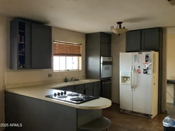 a kitchen with a refrigerator and a sink