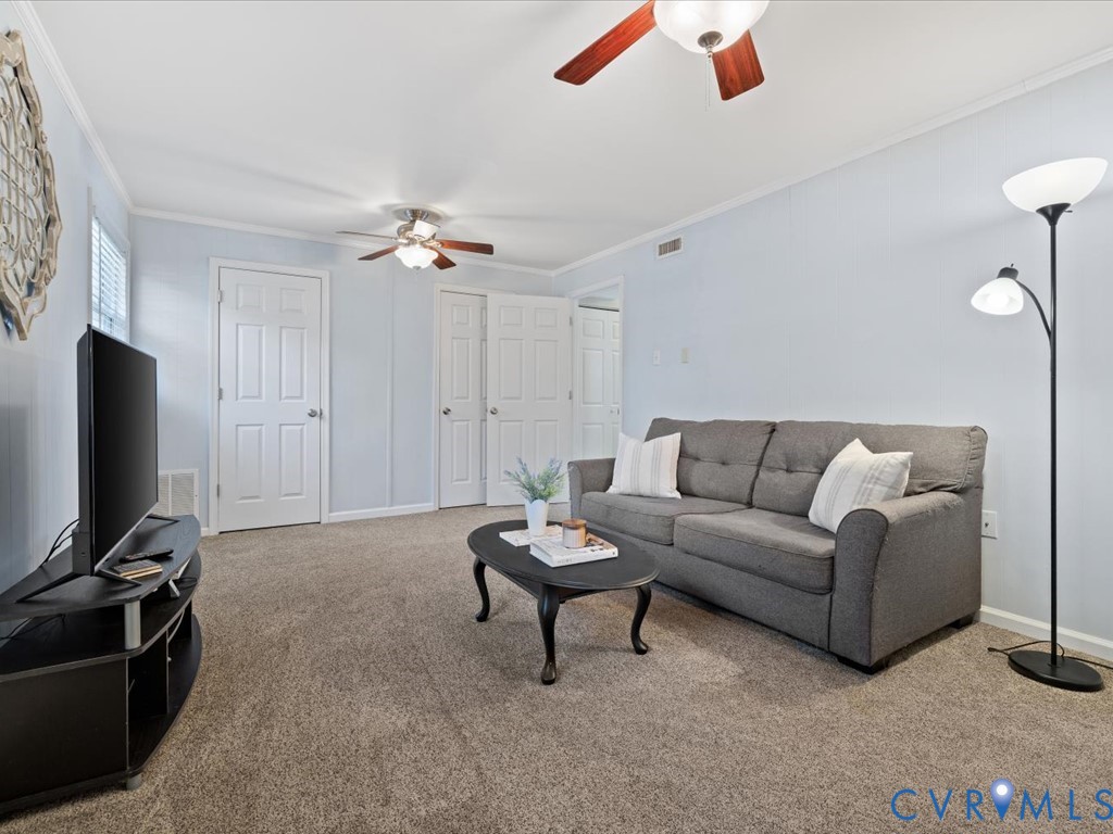 1455 Robindale Road Richmond, VA 23235 - Photo 22 of 29 a living room with furniture a ceiling fan and a rug