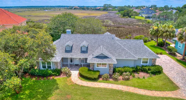 a aerial view of a house with garden and lake view