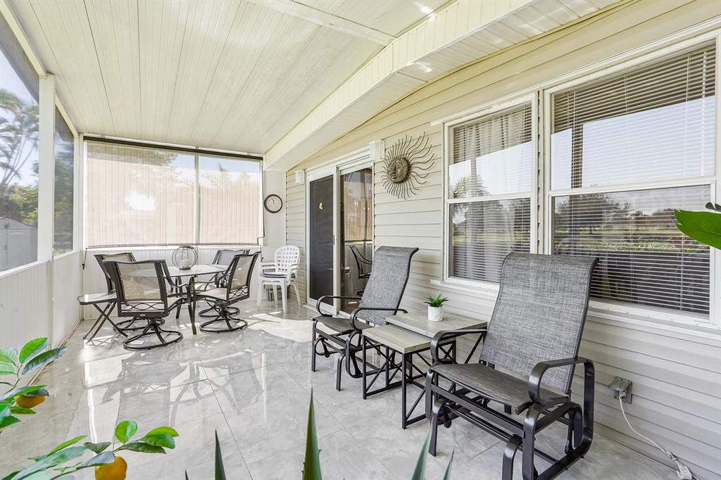 1830 Southwest 83rd Avenue Davie, FL 33324 - Photo 13 of 33 a view of a patio with table and chairs and potted plants