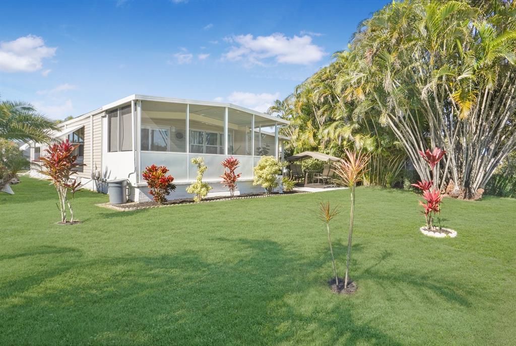 1830 Southwest 83rd Avenue Davie, FL 33324 - Photo 16 of 33 a front view of a house with garden