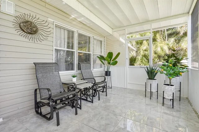 a view of a patio with table and chairs and potted plants