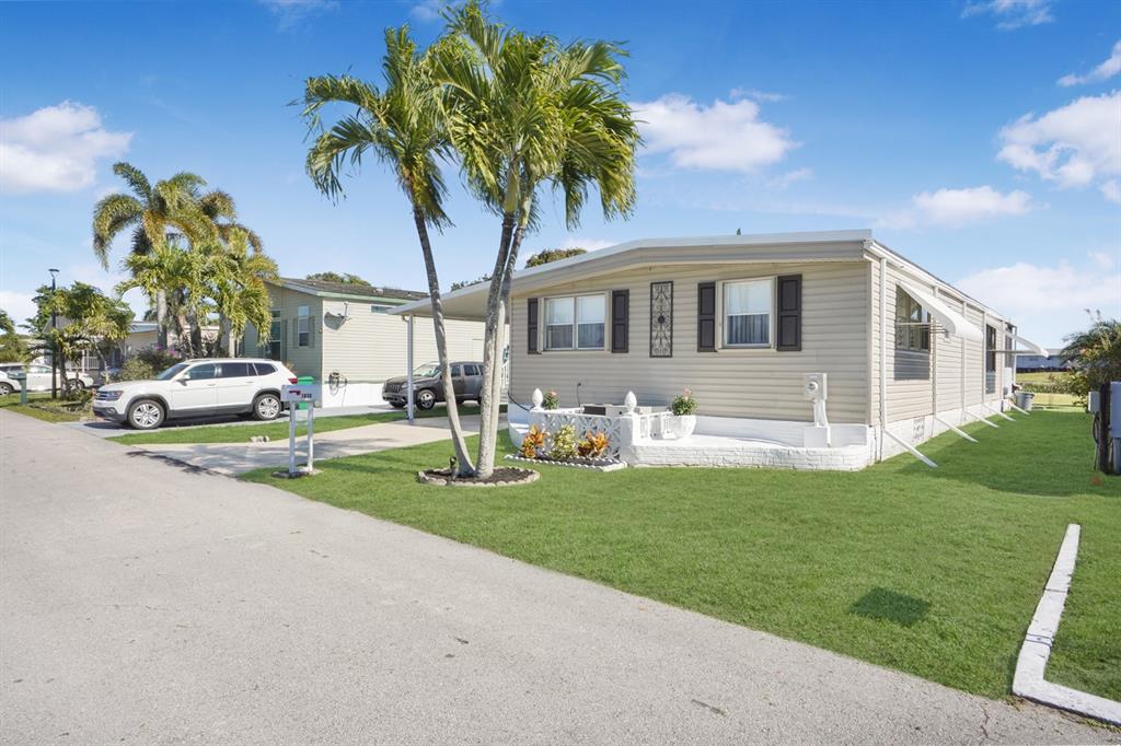1830 Southwest 83rd Avenue Davie, FL 33324 - Photo 29 of 33 a front view of a house with a garden and trees