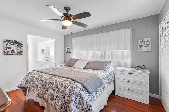 a bedroom with a bed and a ceiling fan