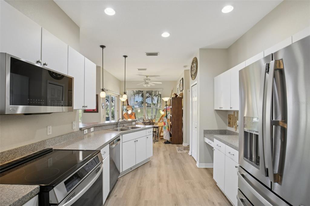 24567 Buckingham Way Punta Gorda, FL 33980 - Photo 13 of 46 a kitchen with stainless steel appliances a stove refrigerator sink and microwave