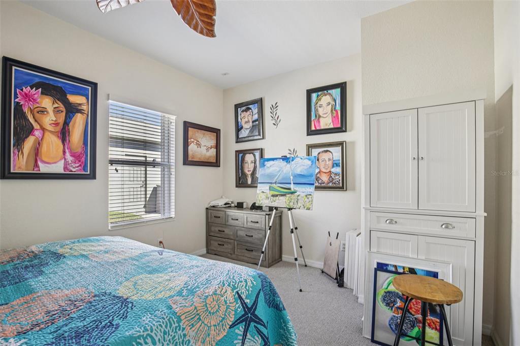 24567 Buckingham Way Punta Gorda, FL 33980 - Photo 25 of 46 a bedroom with a bed and furniture