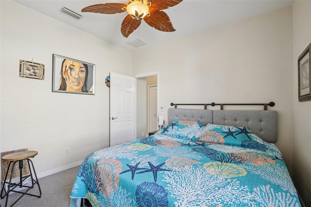 24567 Buckingham Way Punta Gorda, FL 33980 - Photo 26 of 46 a bedroom with a bed and painting on the wall