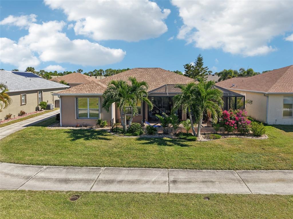 24567 Buckingham Way Punta Gorda, FL 33980 - Photo 35 of 46 a couple of people sitting in front of a house