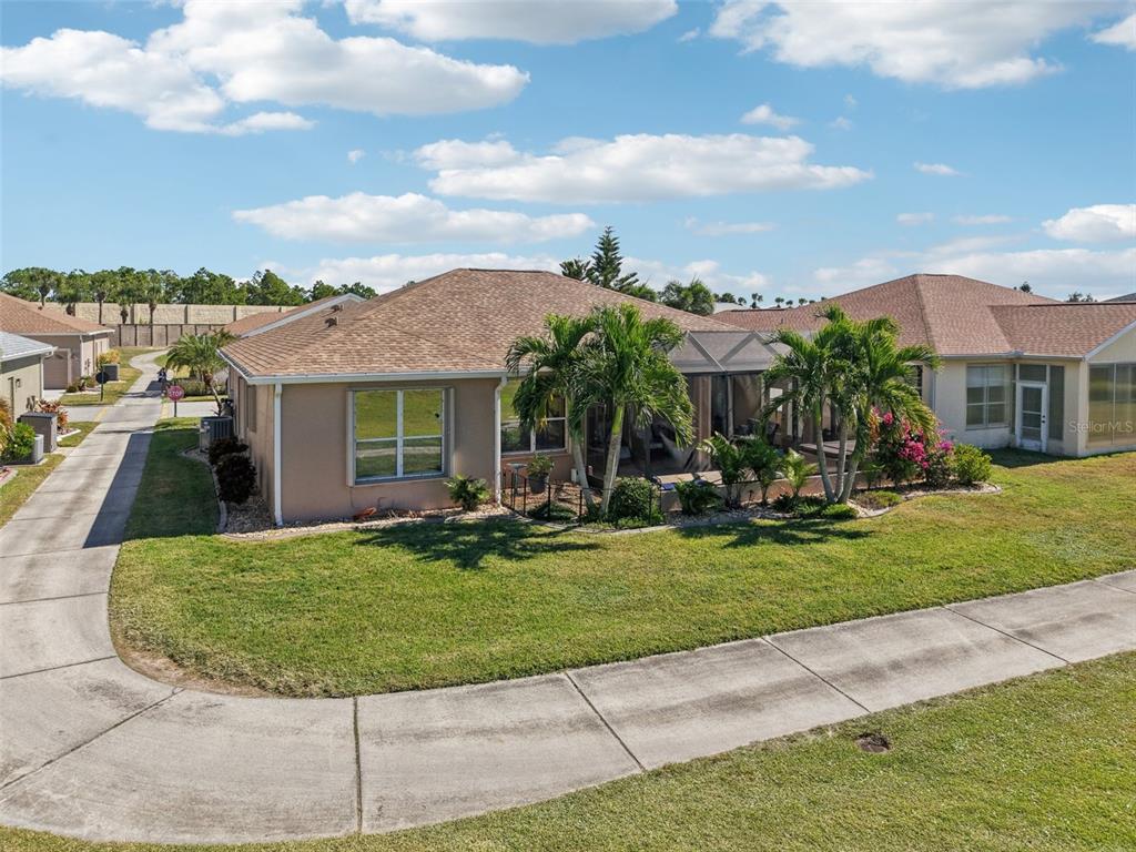 24567 Buckingham Way Punta Gorda, FL 33980 - Photo 39 of 46 a view of a house with a swimming pool and a yard