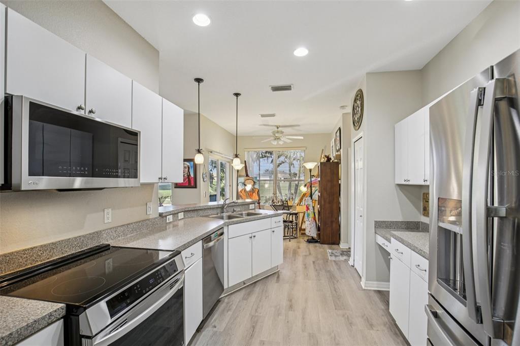 24567 Buckingham Way Punta Gorda, FL 33980 - Photo 9 of 46 a kitchen with a sink stove and refrigerator