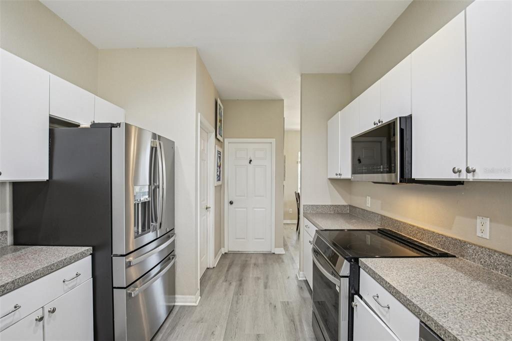 24567 Buckingham Way Punta Gorda, FL 33980 - Photo 10 of 46 a kitchen with stainless steel appliances granite countertop a refrigerator stove and sink