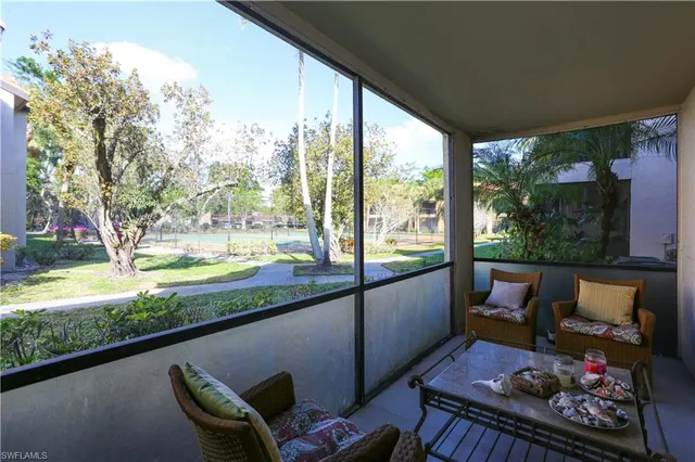 a view of a porch with furniture and a yard