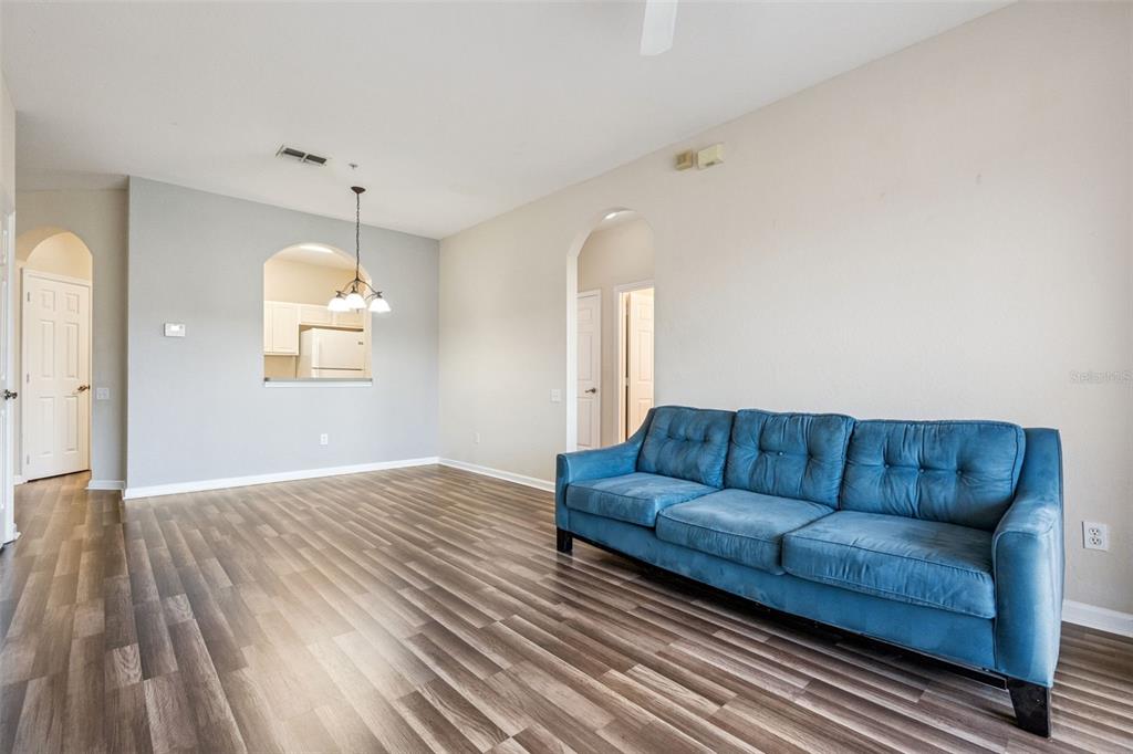 13560 Turtle Marsh Loop, Unit 21 Orlando, FL 32837 - Photo 12 of 30 a living room with furniture and a wooden floor