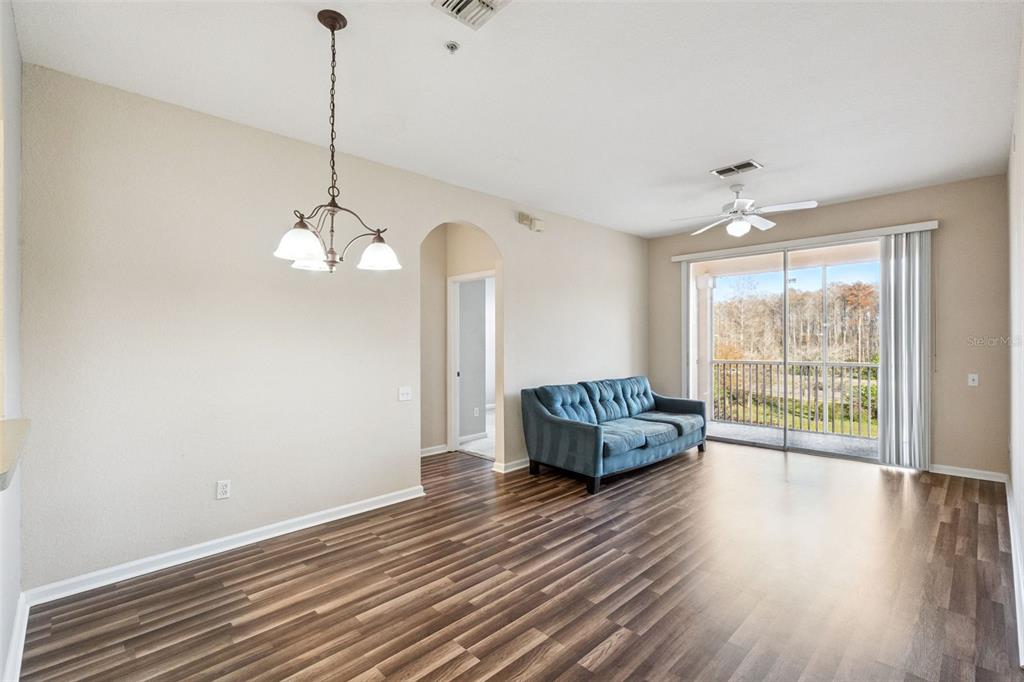 13560 Turtle Marsh Loop, Unit 21 Orlando, FL 32837 - Photo 13 of 30 a view of a livingroom with furniture wooden floor staircase and a chandelier