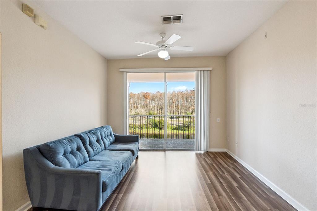 13560 Turtle Marsh Loop, Unit 21 Orlando, FL 32837 - Photo 14 of 30 a living room with furniture and a large window