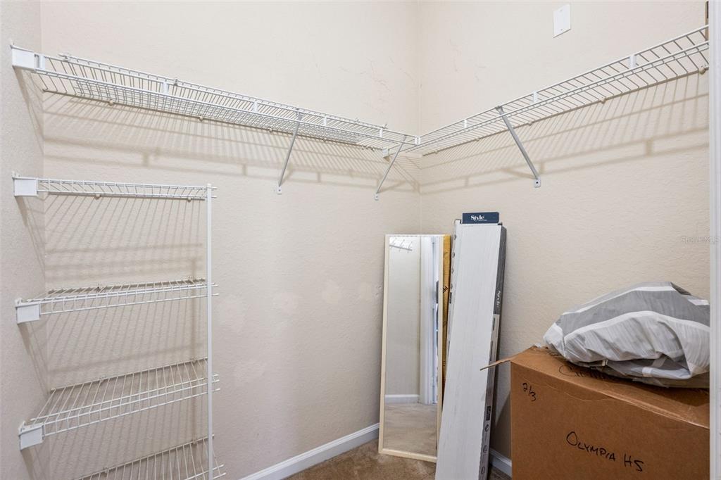 13560 Turtle Marsh Loop, Unit 21 Orlando, FL 32837 - Photo 18 of 30 a view of walk in closet with clothes and shoes