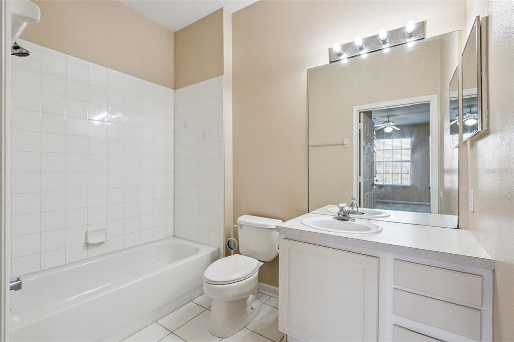 13560 Turtle Marsh Loop, Unit 21 Orlando, FL 32837 - Photo 19 of 30 a bathroom with a sink a toilet and shower