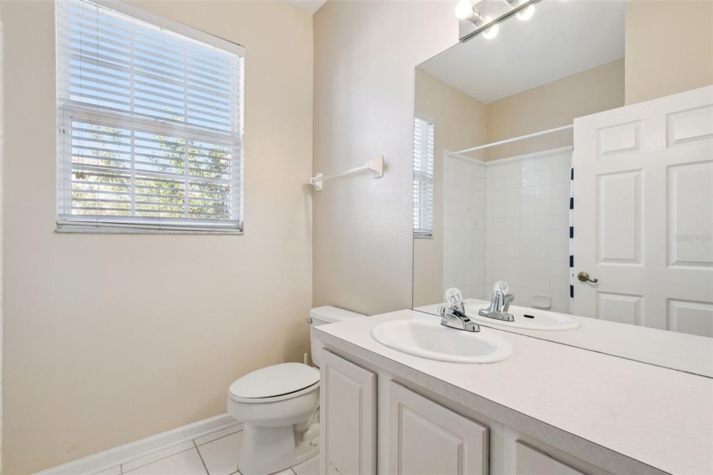 13560 Turtle Marsh Loop, Unit 21 Orlando, FL 32837 - Photo 22 of 30 a bathroom with a sink toilet and a mirror