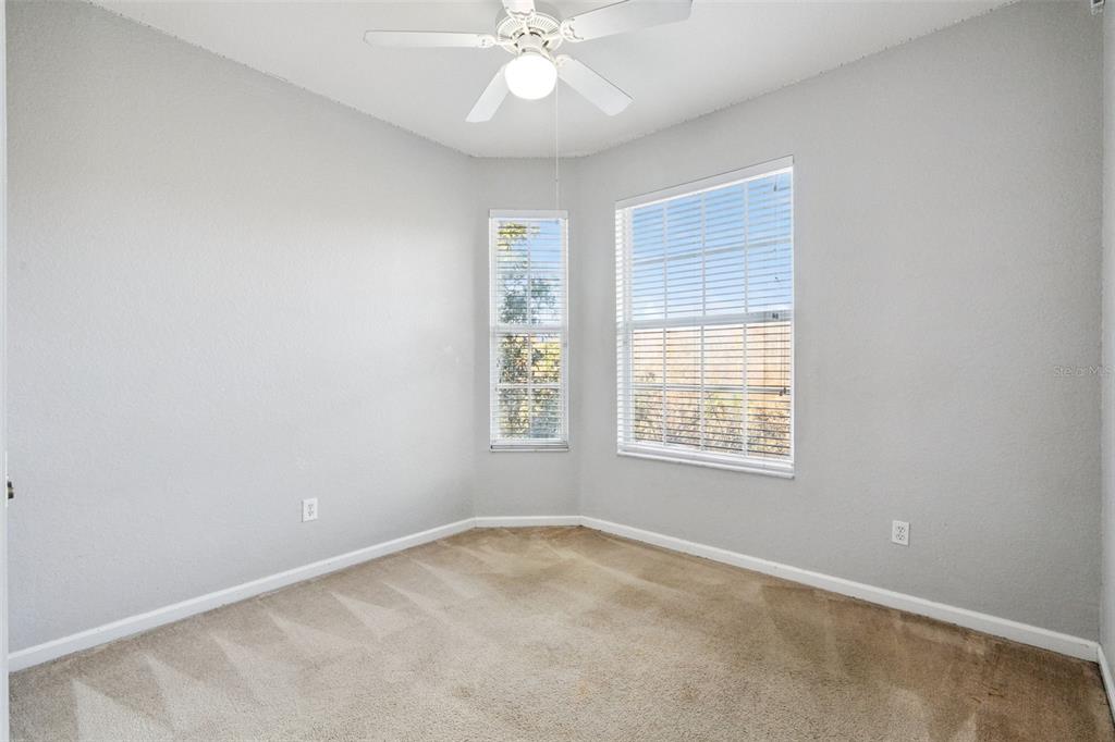 13560 Turtle Marsh Loop, Unit 21 Orlando, FL 32837 - Photo 24 of 30 an empty room with a window and a fan