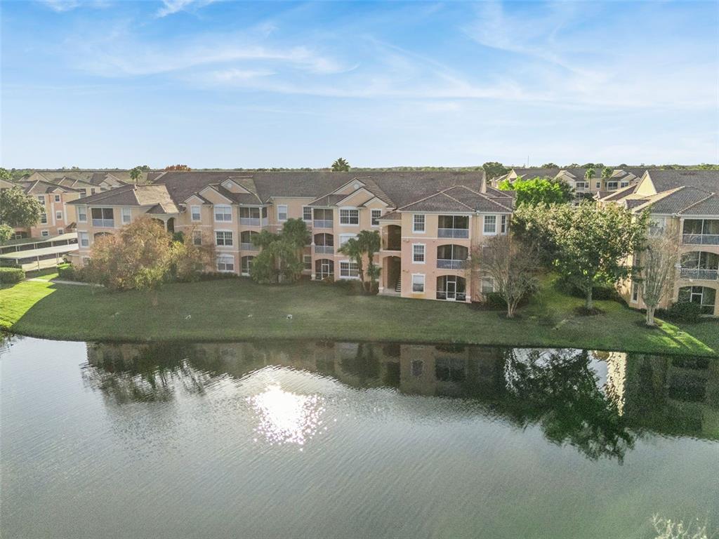 13560 Turtle Marsh Loop, Unit 21 Orlando, FL 32837 - Photo 30 of 30 a view of a lake with a building in the background